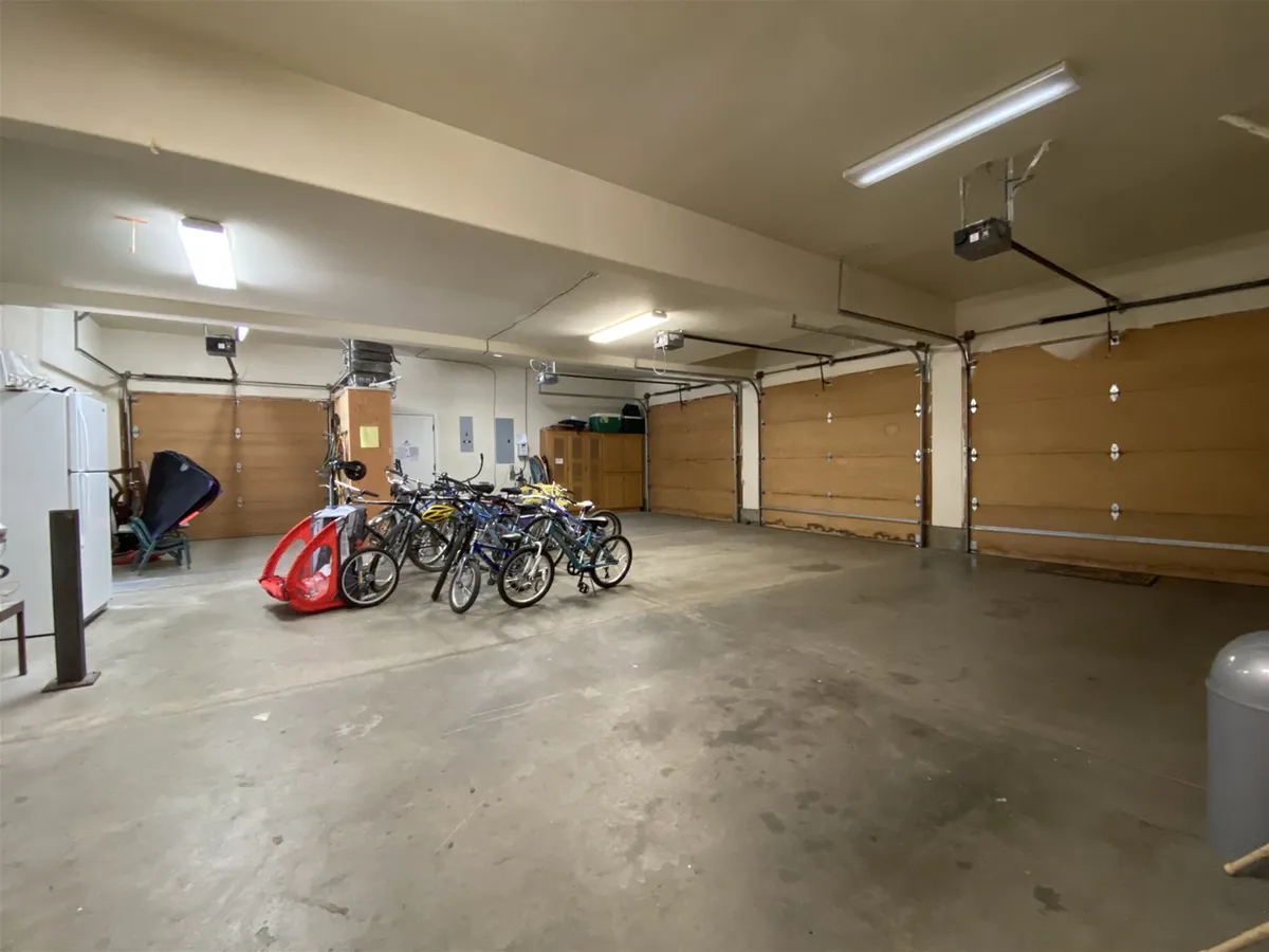 This practical interior shot features several bicycles and storage cabinets, emphasizing the availability of bikes for family outings. It visually supports the mention of 'bikes provided' and the accessibility of biking adventures along Sunriver’s trails.